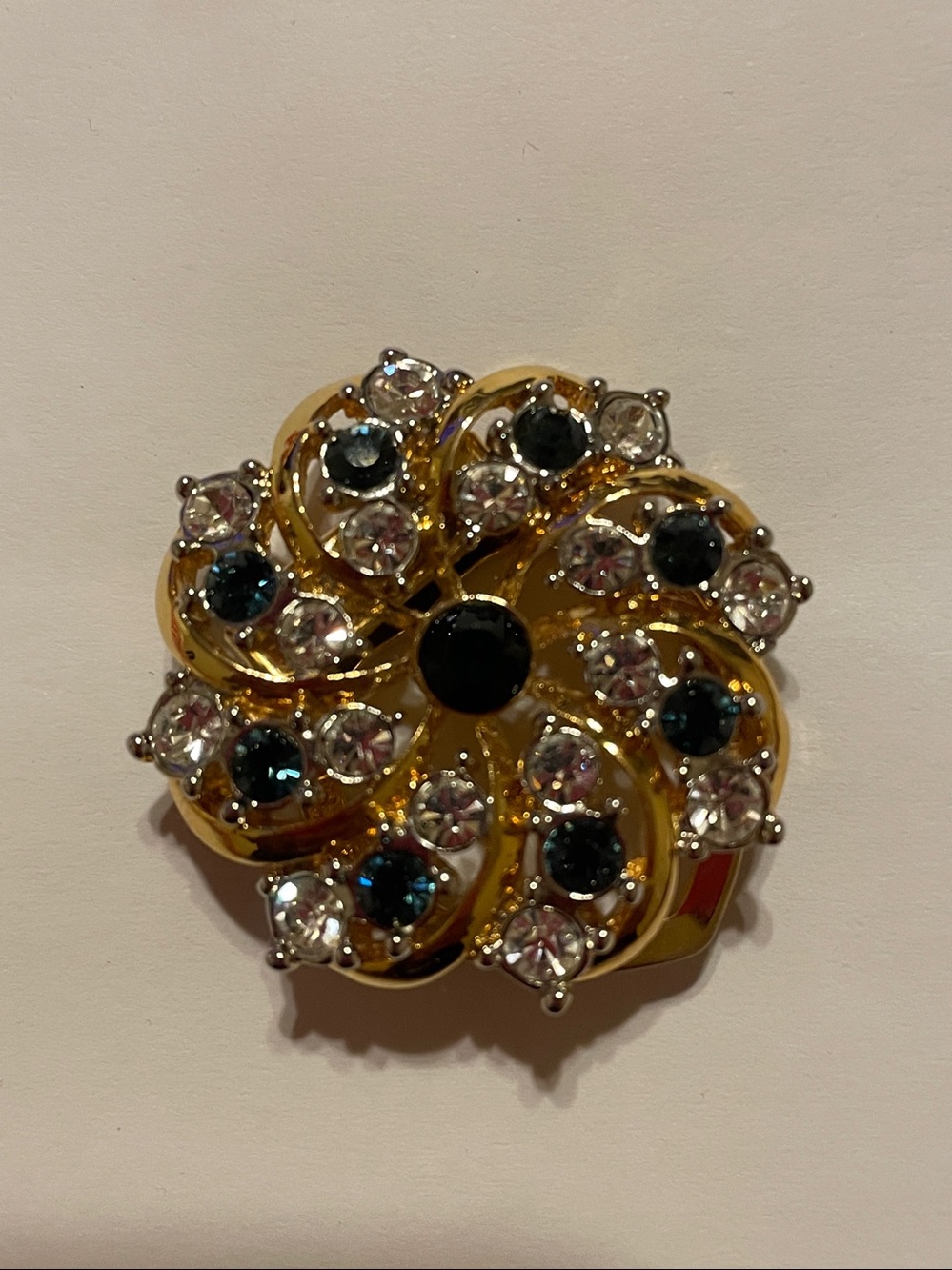 Gold-Tone Floral Swirl Brooch with Clear and Dark Blue Crystals